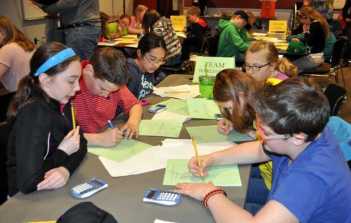 Students in the sixth-grade Harlequin Team from Paris Elementary School work on a math problem. Clockwise, from front left, are Abby Steeves, William Dieterich, Annie Choi, Katerina Crowell, Halie Page and Sebastian Brochu.